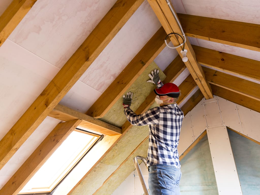 man fixing ceiling weatherization program