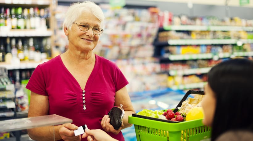 senior woman supermarket cashier snap benefits