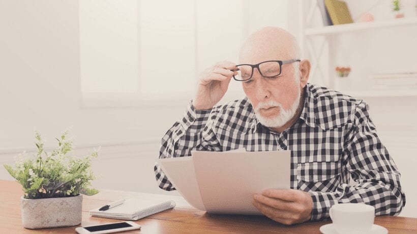 senior looking at papers TANF