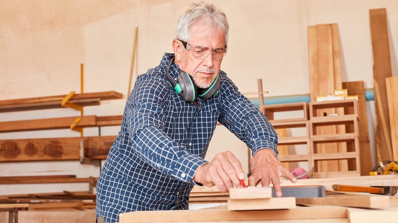 older man working on wood snap working requirements