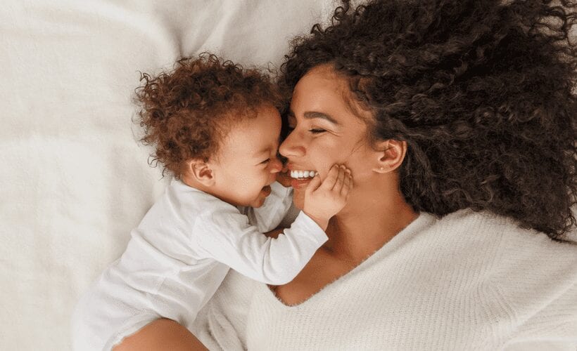 woman with baby in bed chip health plan