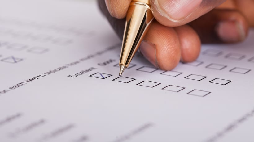 person checking box on a form applying for medicaid