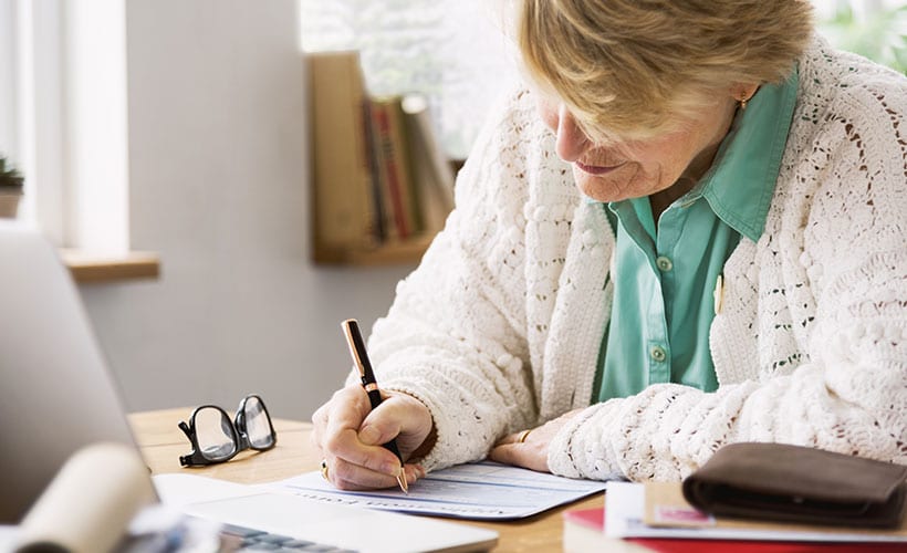 senior woman filling out form apply for ssi