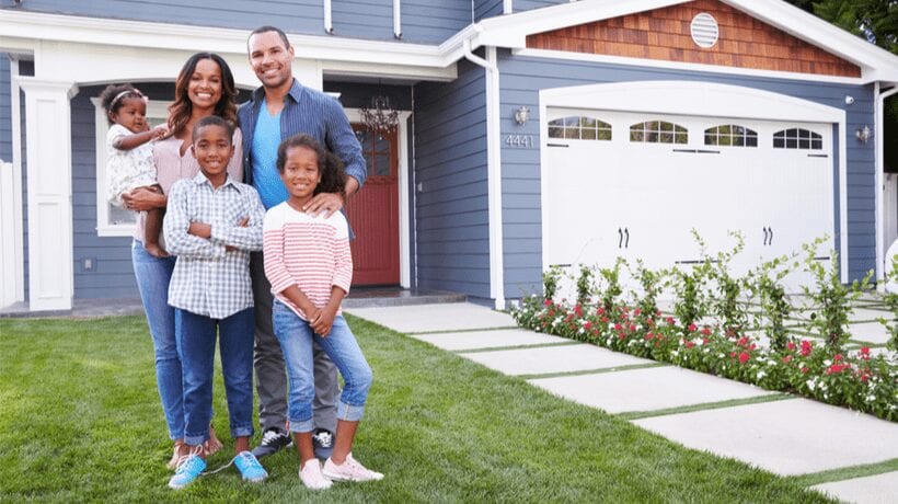 happy family in front of house monthly housing allowance