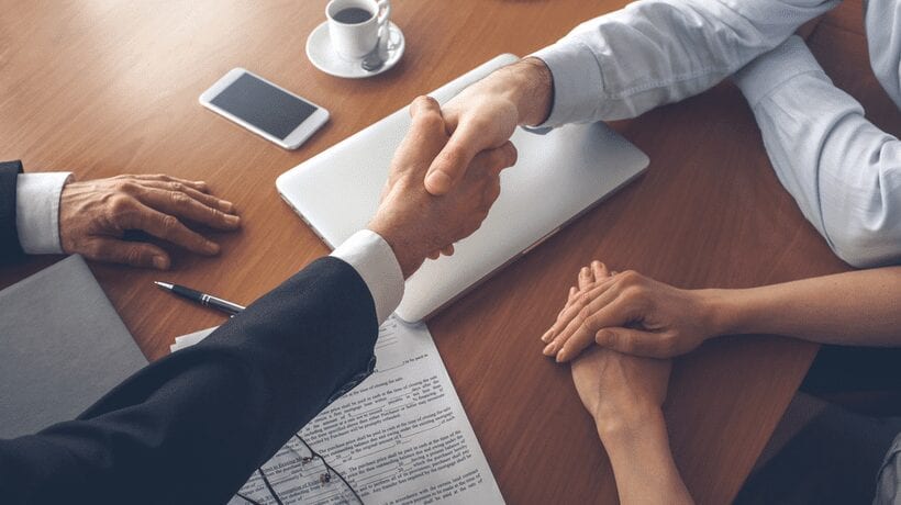 men shaking hands closing costs