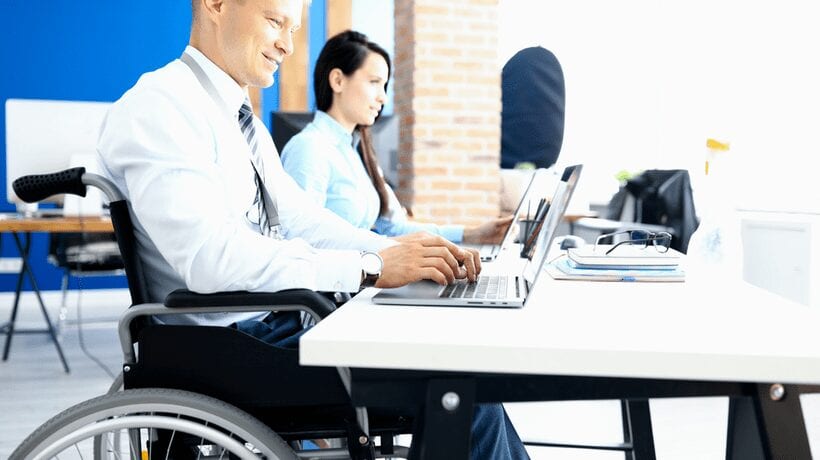 disabled man working at office Reemployment Track