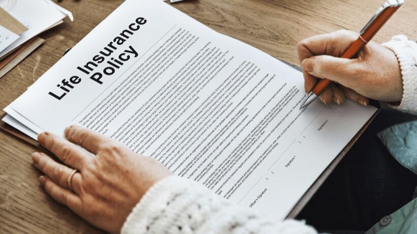 woman signing life insurance policy va life insurance