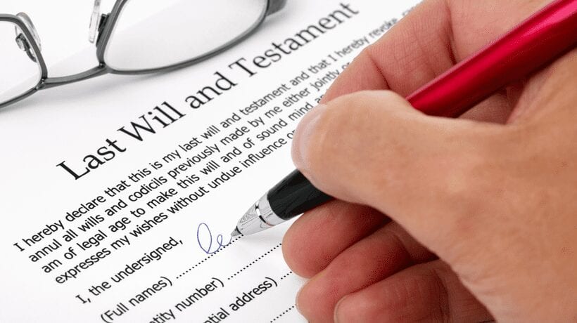 woman signing last will an testament will preparation